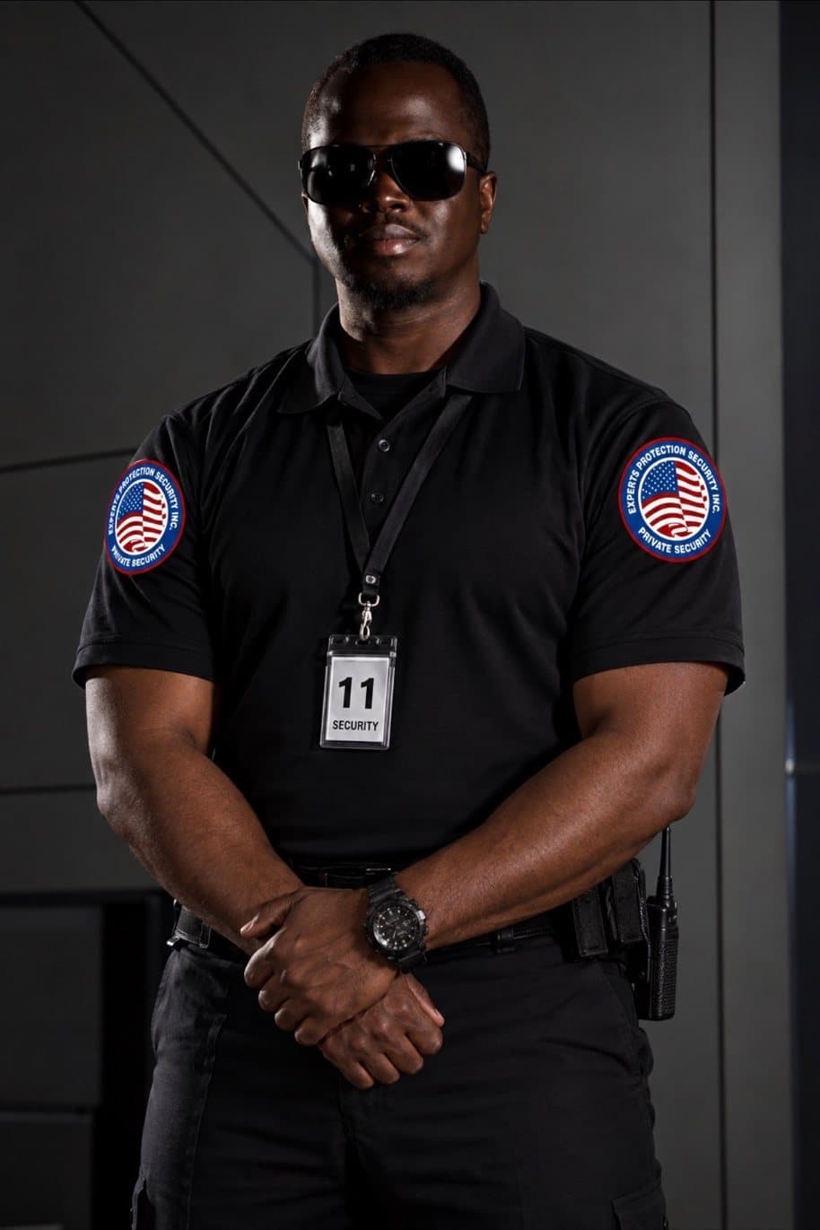 Officer in a black polo with company patches on both shoulders